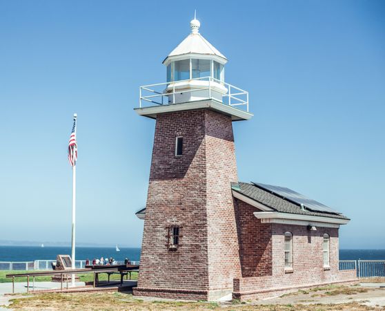 Old beacon near sea in sunny weather