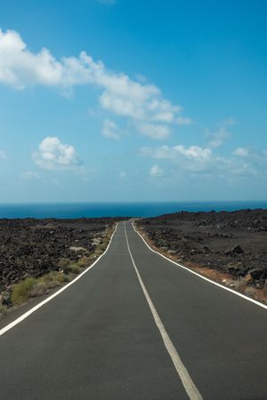 Empty road leading to ocean in Lazarote