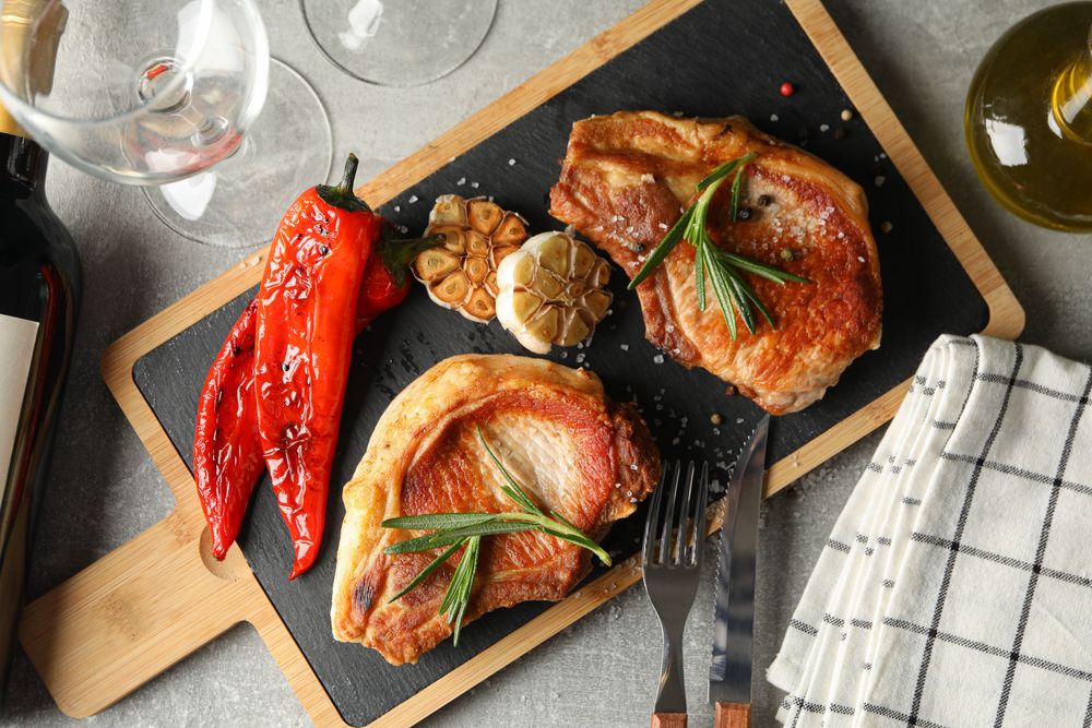 Composition with fried steaks and wine. Grilled food