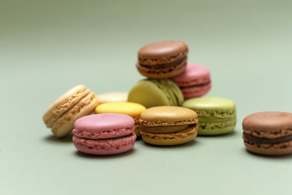 Macaroons scattered on a green table