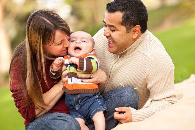 Happy Parents Playing with Their Son