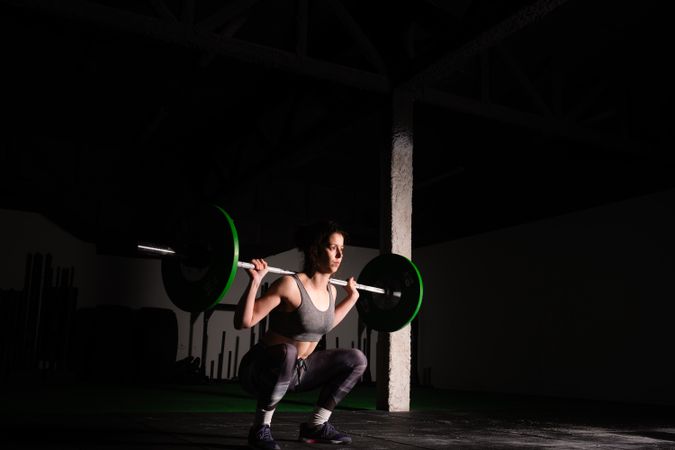 Woman lifting barbell in gym