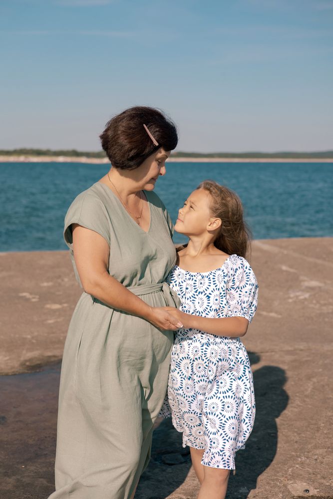 Grandmother and granddaughter by the sea