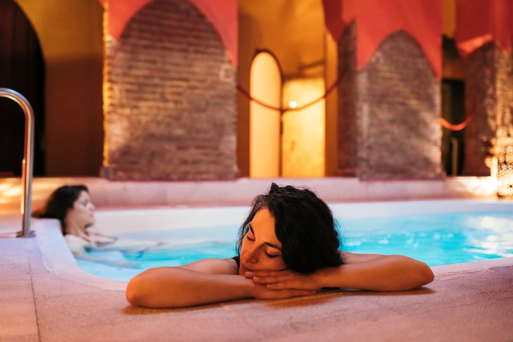 Woman resting head on side of pool
