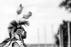 Red Wing, MN, USA - July 8th, 2017: Profile of Native American man in traditional headdress