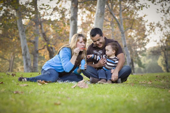 Family Playing with Bubbles In The Park