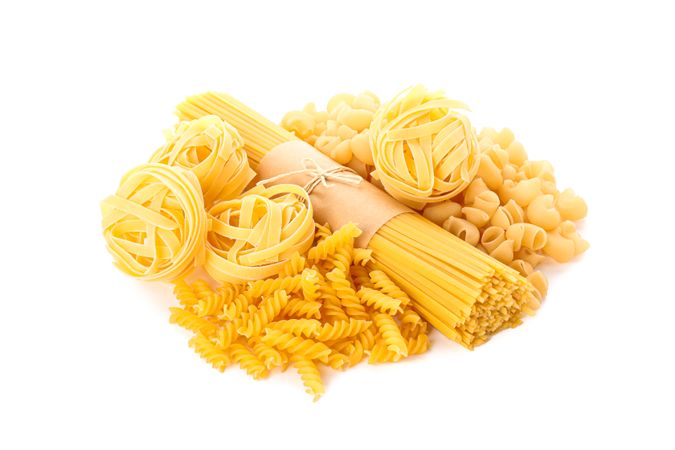 Pasta isolated on bright background. Uncooked whole wheat pasta
