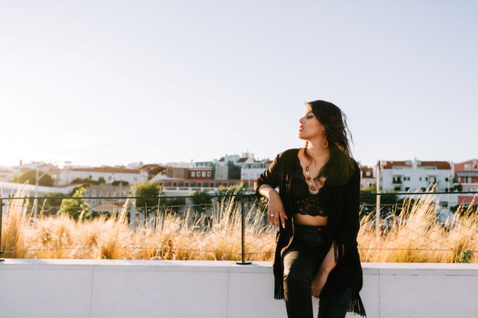 Trendy female standing on urban background