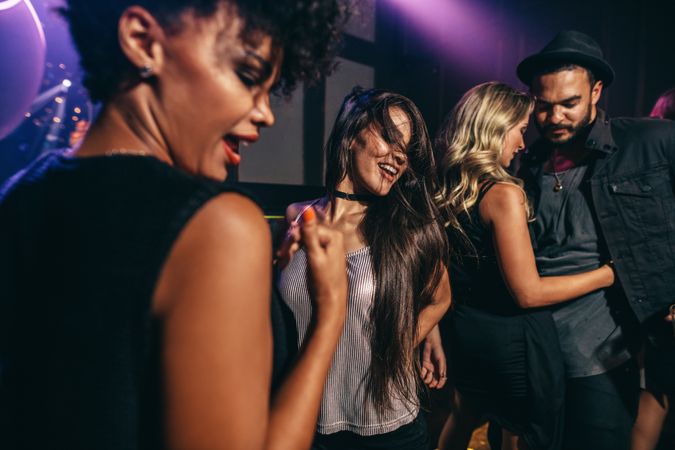 Group of young friends having fun together at nightclub