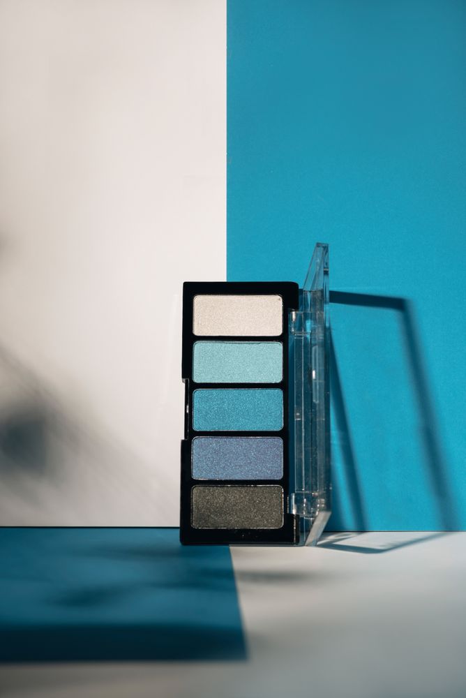 soft blue eyeshadow palette on geometric background.
