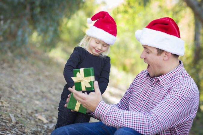 Father Giving Young Daughter Christmas Gift