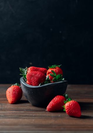 Fresh ripe strawberries in concrete bowl