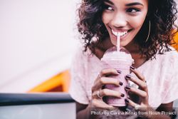 Young woman happily drinking a milk shake n56vL5