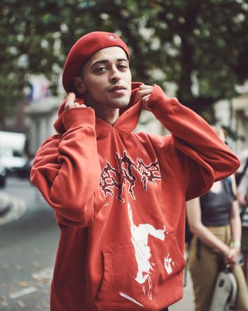 London, England, United Kingdom - September 18 2021: Man in red hoodie and hat