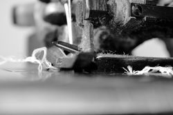 Side view close up of sewing machine needle