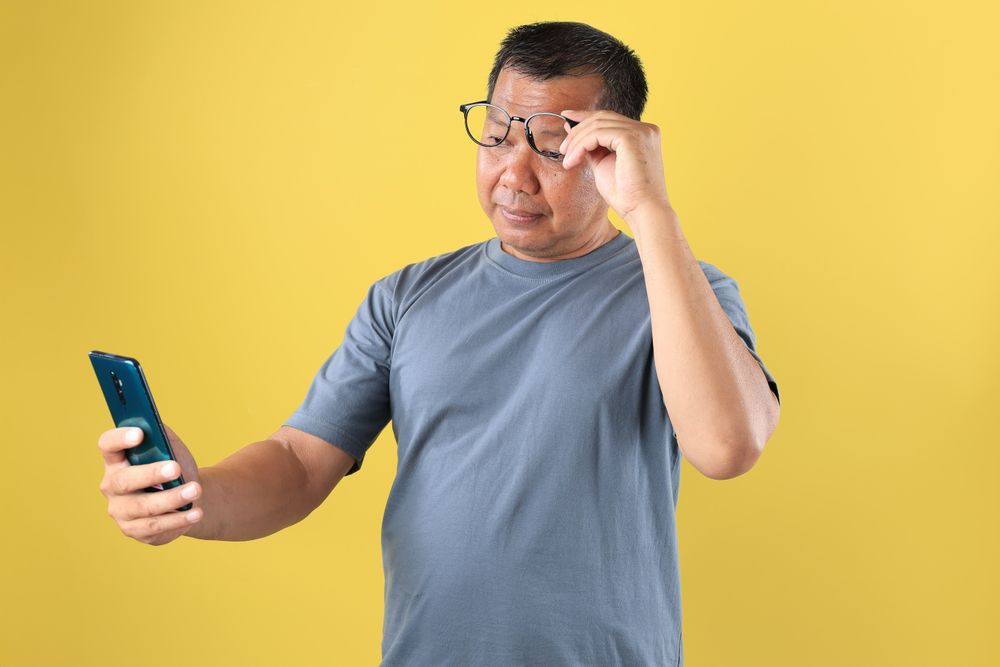 Mature Asian Man with Presbyopia