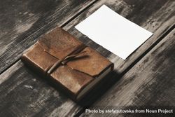 Leather-bound notebook and paper on wooden table bG2XB4