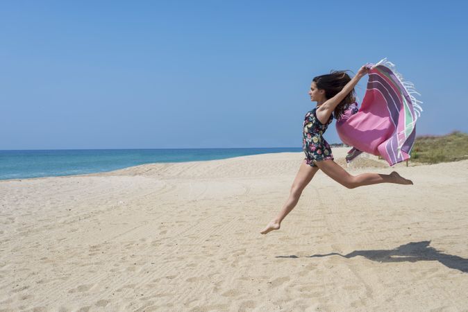 Woman jumping with sarong