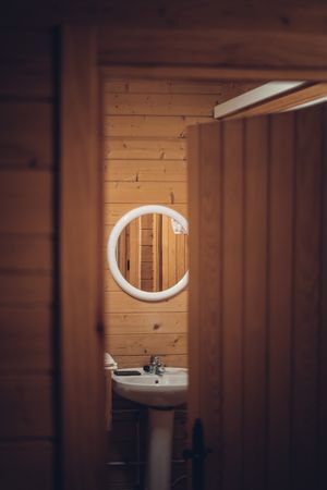 Bathroom in wooden house with opened door