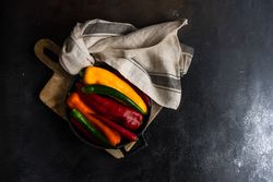 Fresh raw bell peppers in a pan with copy space