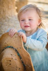 Adorable Baby Girl with Cowboy Hat at the Pumpkin Patch.