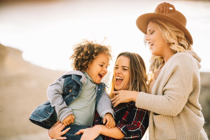 Smiling blond women walking with curly child
