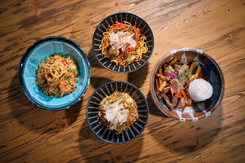 Appetizing dishes served in bowls on wooden table