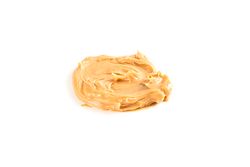 Creamy peanut butter isolated on bright background. A traditional product of American cuisine