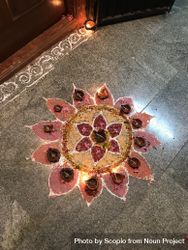Top view of Rangoli on floor with lit diyas 5RzDr5