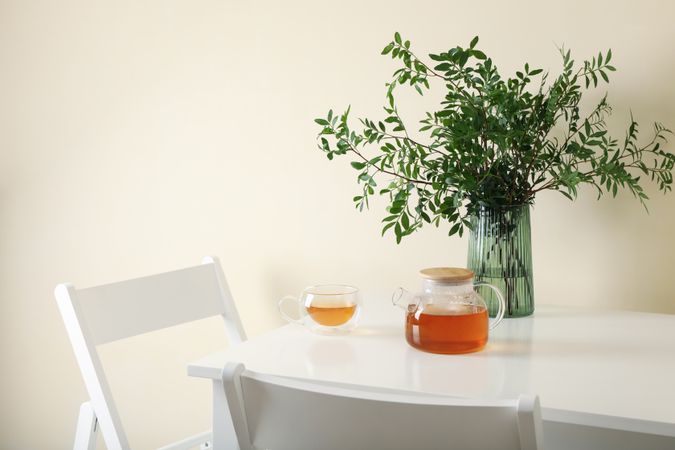 kitchen table with tea and plant in bright room