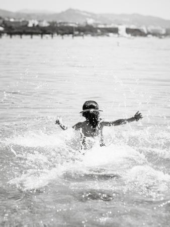 Cheerful girl having fun in warm sea