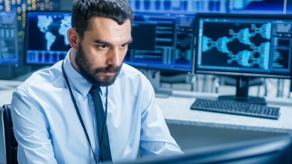 In the System Control Center Technical Operator Monitors Displays at His Workstation.
