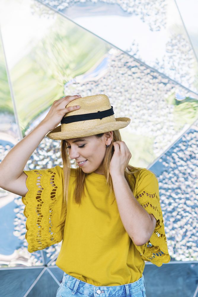Stylish woman posing in straw hat