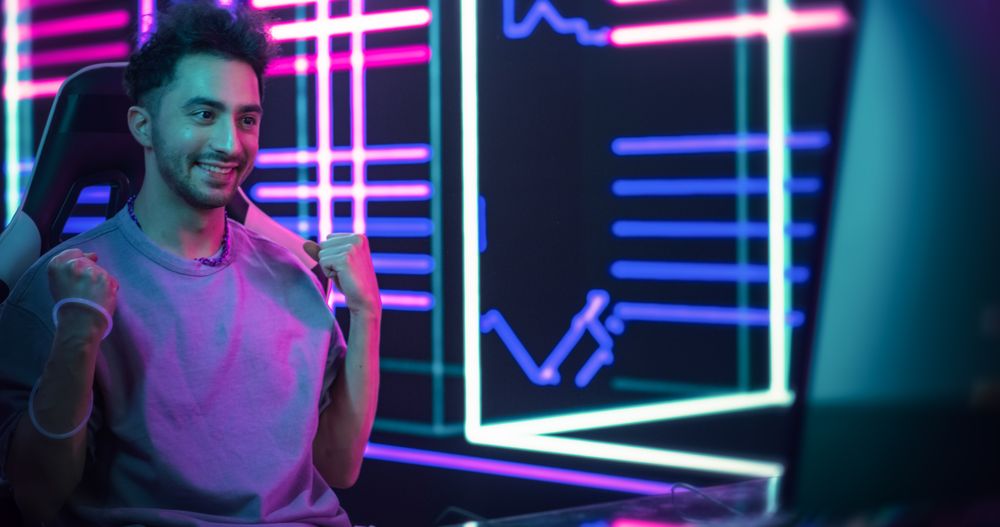 Excited Handsome Man Playing Video Games with Friends on a Computer, Surrounded by Cyberpunk Style Background.