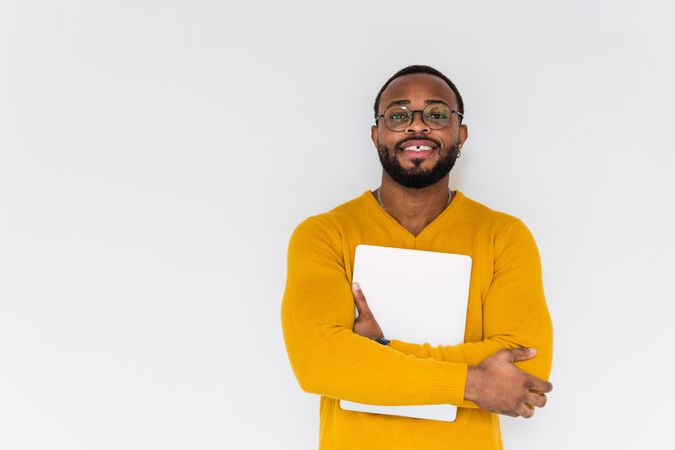 Smiling Black man with laptop