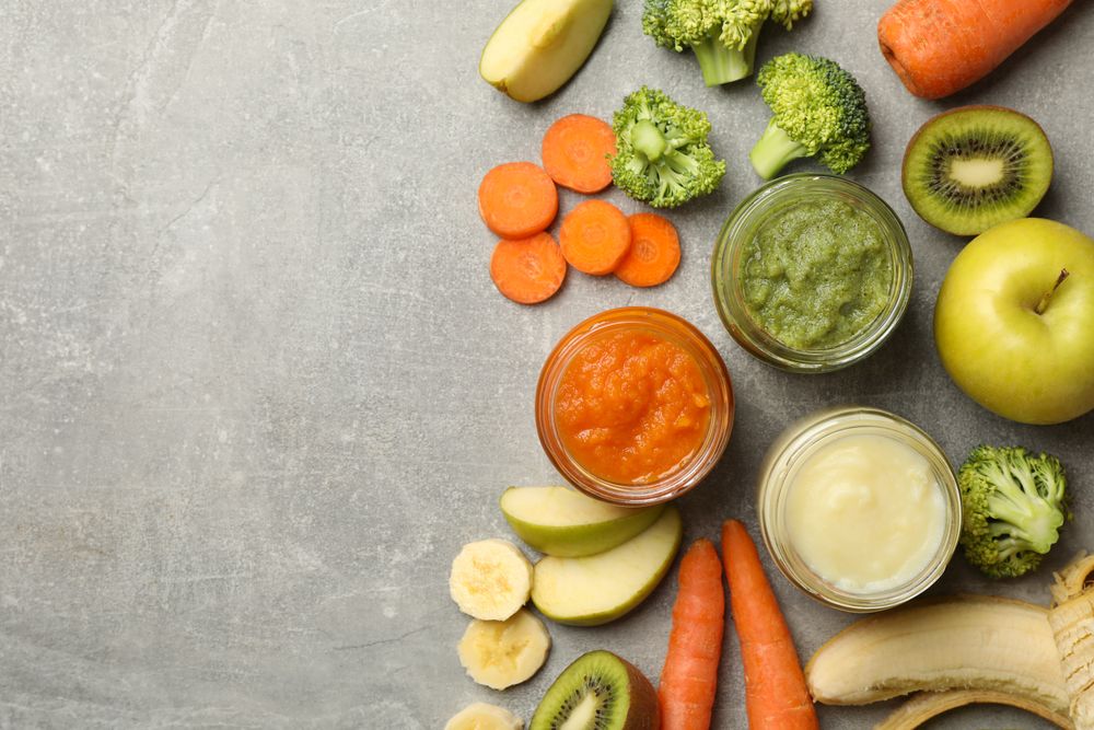 Composition with baby food on gray background, top view