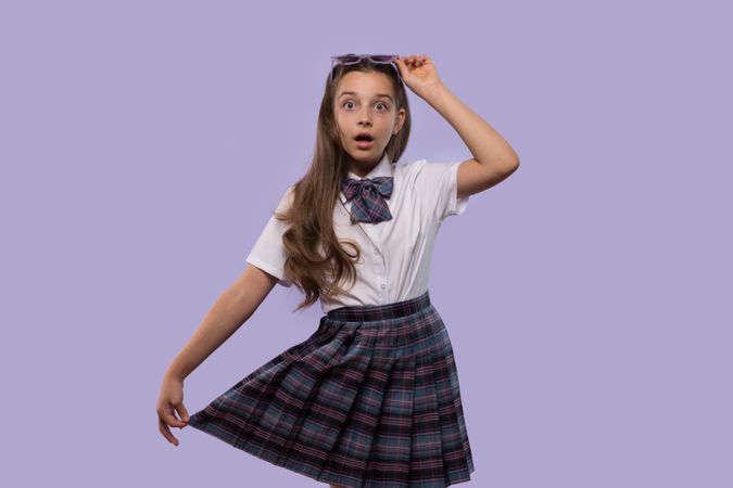 Girl looking surprised while adjusting purple sunglasses