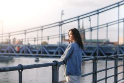 Woman standing at the railing along the waterfront
