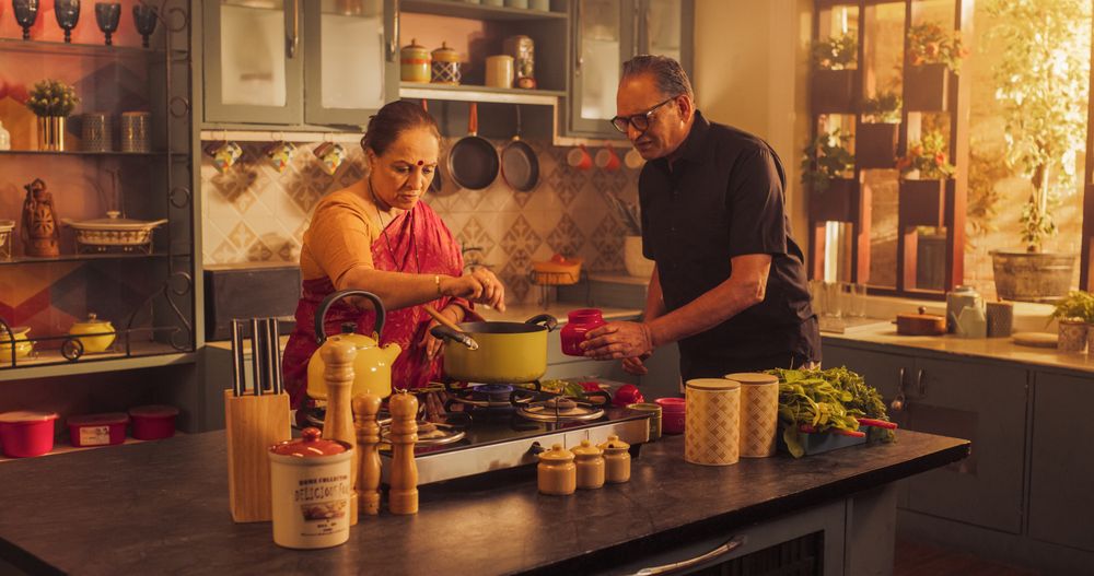 Indian Couple Exploring Traditional Cooking: Preserving Culinary Heritage, Preparing Authentic Recipes with Love and Care.