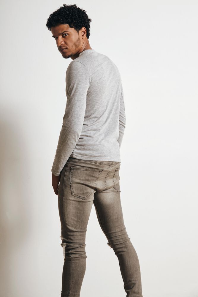 Full length shot of serious man dressed in grey looking around