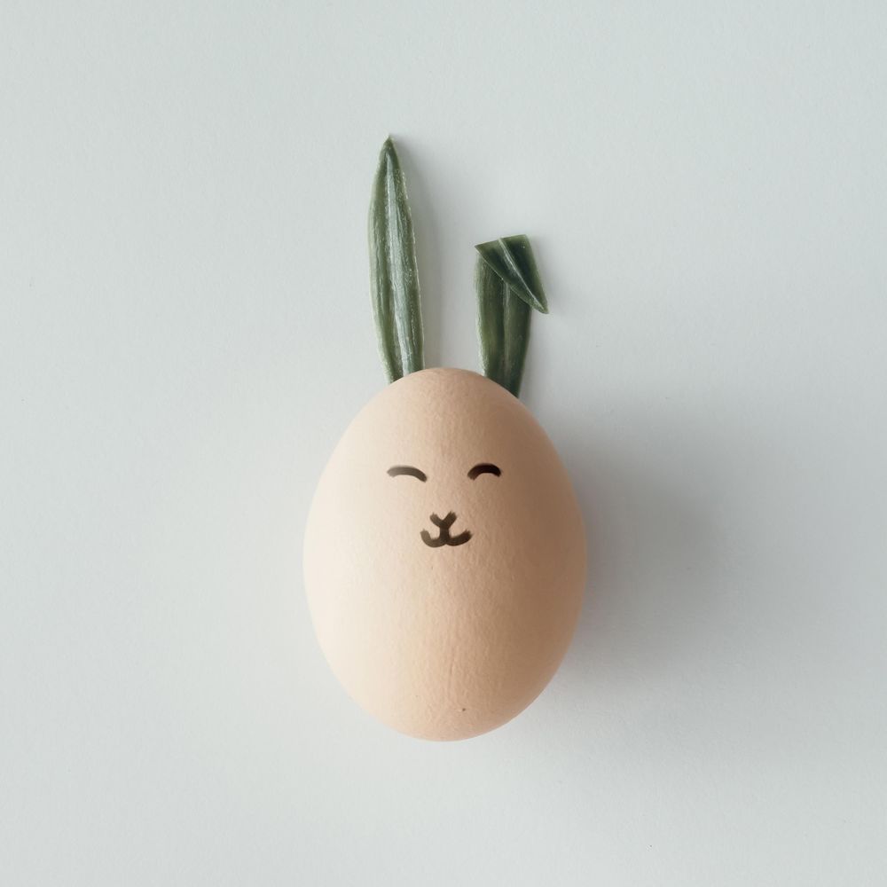 Easter egg with bunny ears and face