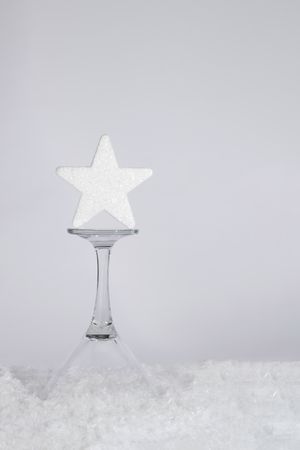 Christmas sparkling star standing on drinking glass
