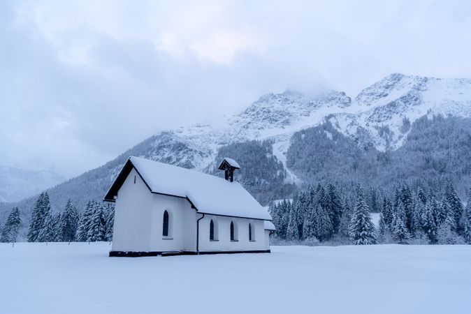 Snow-covered church minimalist in a winter scenery in the Bavarian Alps, Germany