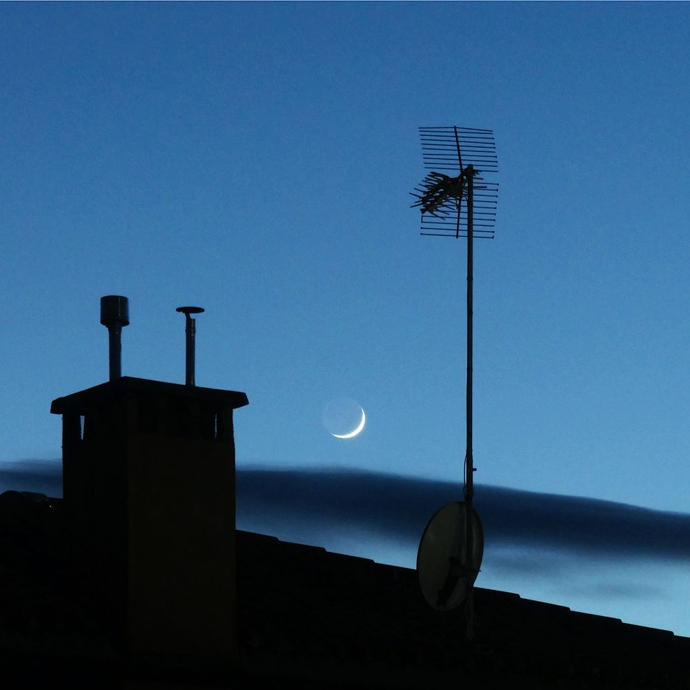 Moon above the roof