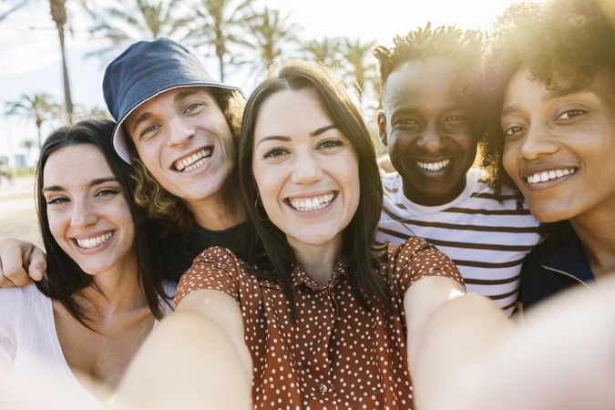 Group of happy multiracial people taking a selfie with mobile phone