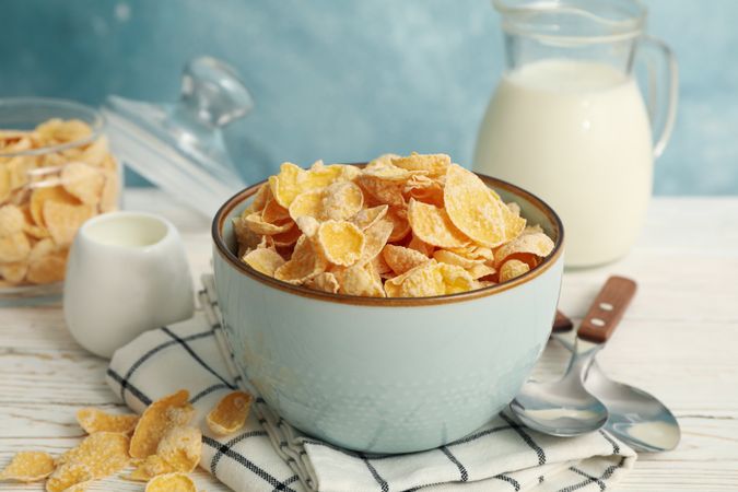 Concept of breakfast with muesli and milk on wooden table