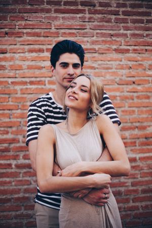 Happy couple having fun and embracing in the street