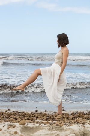 Charming young woman on shore near water