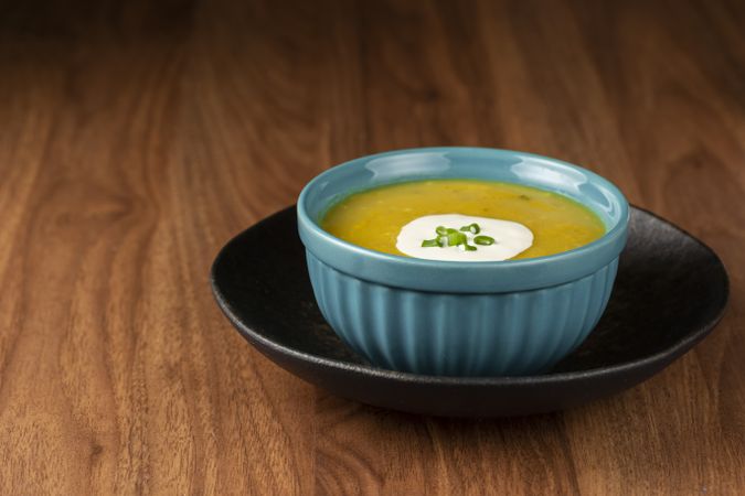 Bowl with pumpkin soup on the table.