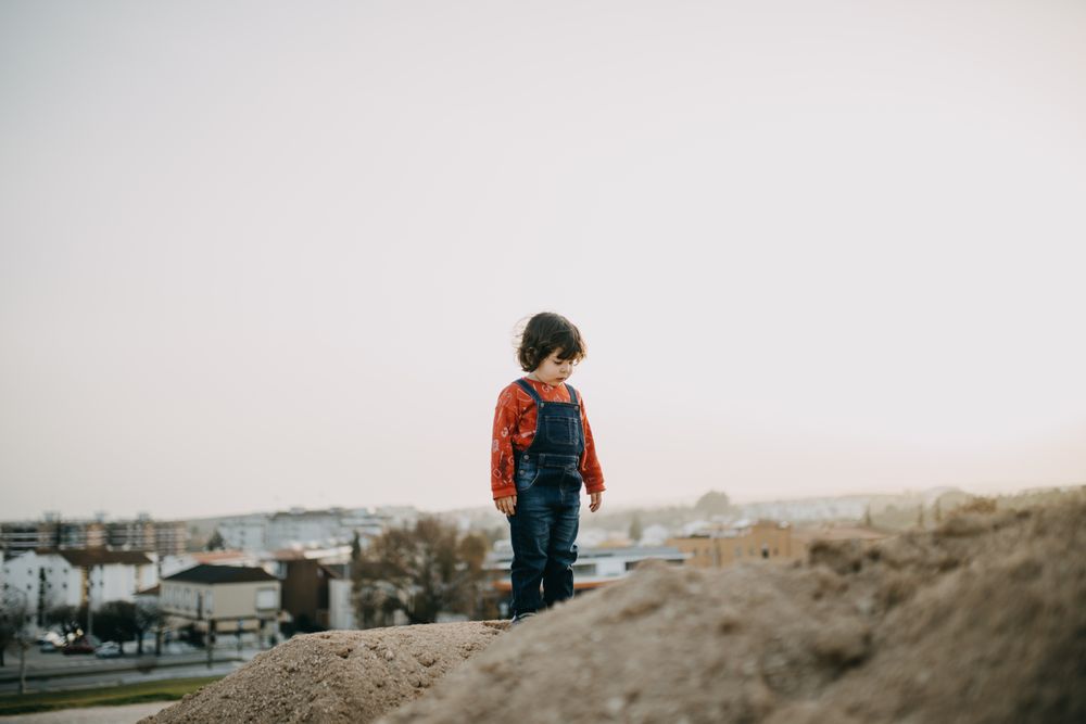Young girl on a mound outside of the city